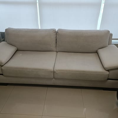 ספה בהירה עם כתמים קלים על הרצפה