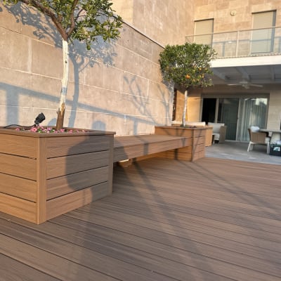 אדניות עץ עם עצים על דק חיצוני