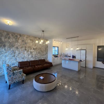 A modern living room and kitchen with lighting fixtures.