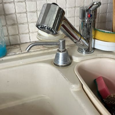 ברז מטבח עם ידית מתכת וכיור לבן