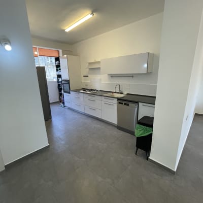 מטבח מודרני עם ארונות לבנים ותאורה בהירה