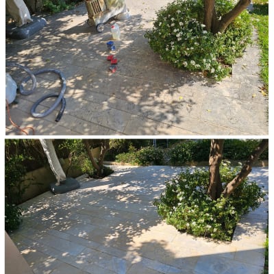 מוצרים וכלים לניקוי חצר מרוצפת ליד שיחים ועצים