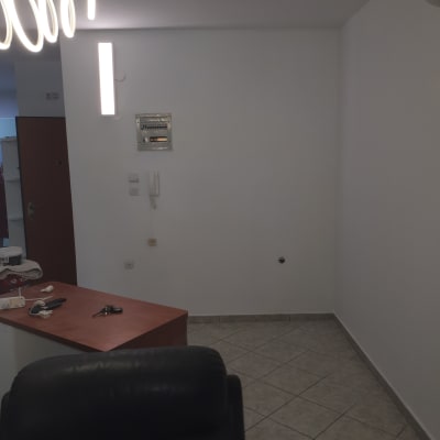 קיר לבן עם תאורה, שולחן עם חפצים