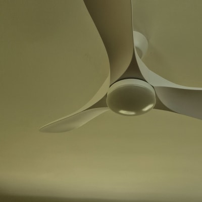 מאוורר תקרה לבן בחדר עם חלון ותריסים