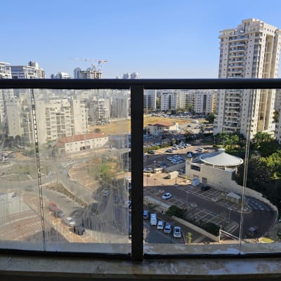 זכוכית מלוכלכת עם סימני ניקוי על מעקה מרפסת