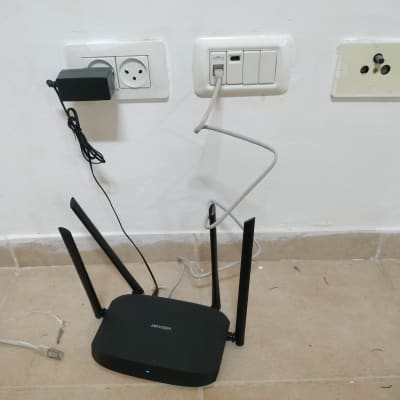 נתב עם אנטנות מחובר לשקע חשמל ולכבל רשת