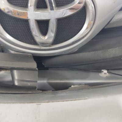 סמל טויוטה על גריל רכב עם נזק קל
