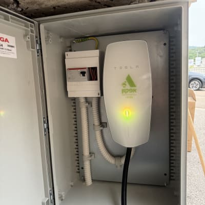 תיבת חשמל עם מטען טסלה וכבלים