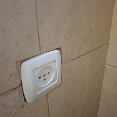 שקע חשמלי מותקן על קיר אריחים