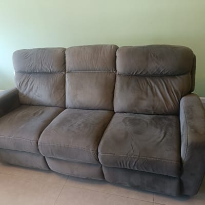 ספה אפורה עם כתמים קלים על הרצפה