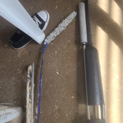 חלקי דוד שמש על הרצפה, כולל גוף חימום ומוטות מתכת