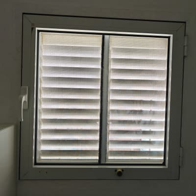 חלון עם תריסים סגורים בחדר פנימי