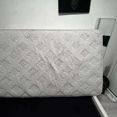 מזרן לבן עם דוגמאות על מיטה