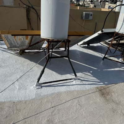 גג אטום עם חומר לבן סביב דודי שמש