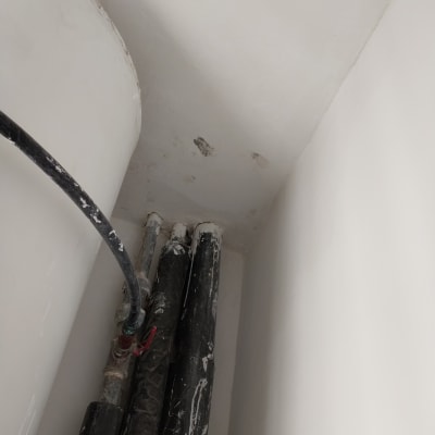 צינורות עם כתמי צבע על קיר לבן