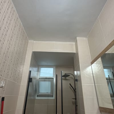 חדר אמבטיה עם מקלחון, אריחים ומראה