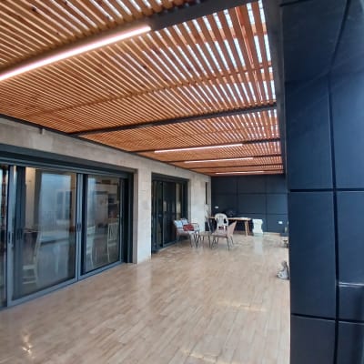 פרגולה מעץ עם קורות עץ על תקרה