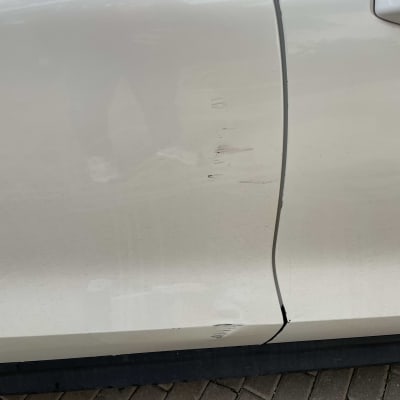 שריטות על דלת רכב לבנה