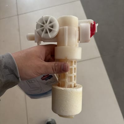 יד מחזיקה חלק פלסטיק של אינסטלציה עם גלגל שיניים