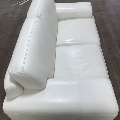 ספה לבנה נקייה על רצפת עץ כהה