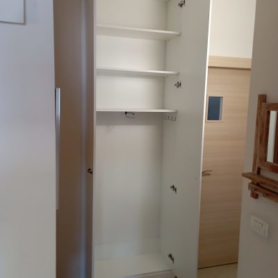 ארון לבן פתוח עם מדפים ודלתות