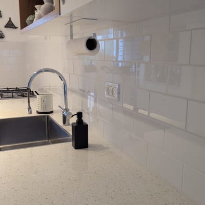 מטבח עם כיור, ברז, ומתקן לנייר מגבת