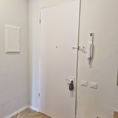 דלת לבנה עם מנעול חכם ומנעול בריח