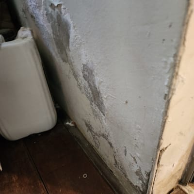 קיר עם סימני רטיבות והתקלפות צבע