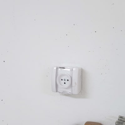 שקע חשמל עם כיסוי שקוף על קיר לבן