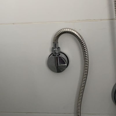 צינור מתכת מחובר לקיר בחדר אמבטיה