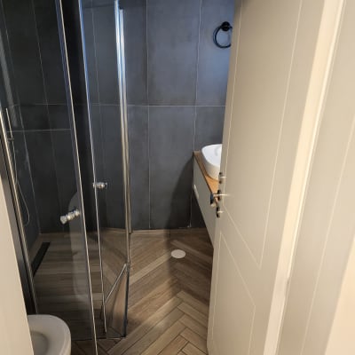 מקלחון זכוכית ושירותים בחדר אמבטיה נקי