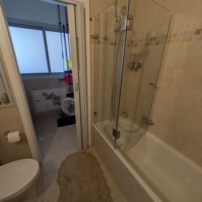 חדר אמבטיה עם אמבטיה, דלת זכוכית ומקלחת