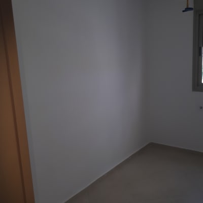 קיר צבוע בלבן בחדר ריק עם רצפת אריחים