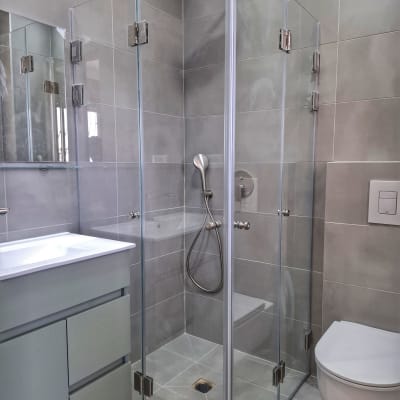 מקלחון זכוכית עם ראש מקלחת בחדר אמבטיה מודרני