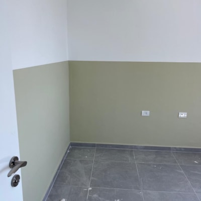 קיר צבוע בשני גוונים, לבן וירוק בהיר.