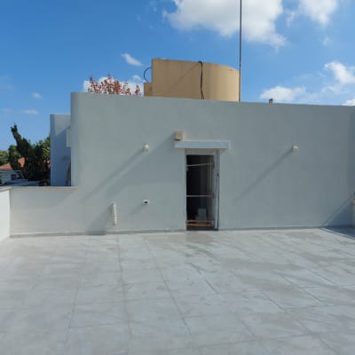 גג מרוצף עם דלת כניסה ומיכל מים גדול
