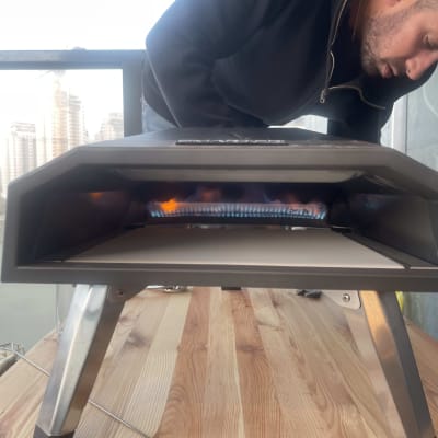 תנור גז נייד על שולחן עץ במרפסת