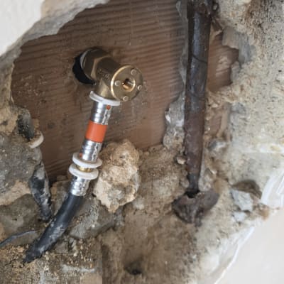 חיבור צנרת מים בקיר עם אביזרי אינסטלציה