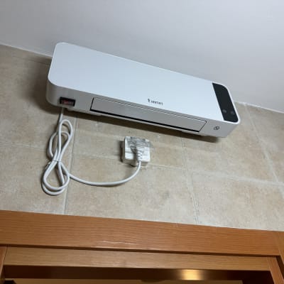 מכשיר חשמלי מותקן על קיר עם כבל חשמל