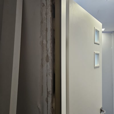 תמונה של דלת פתוחה עם קיר חשוף