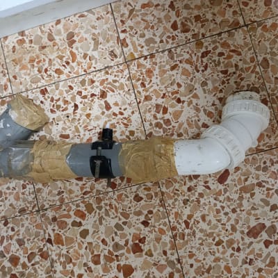 צינור עם תיקון בעזרת סרט דבק על רצפה