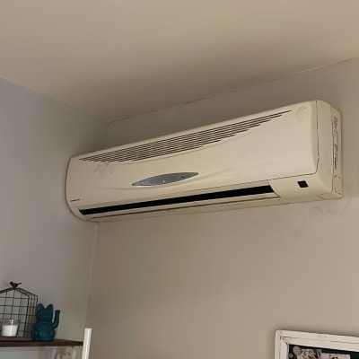 מזגן קיר לבן מותקן על הקיר בחדר