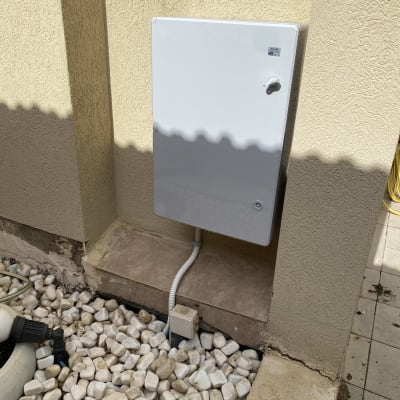 ארון חשמל מותקן על קיר חיצוני עם חיבורים חשמליים