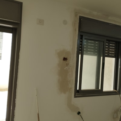 קיר עם חוטי חשמל ותקע חשמלי