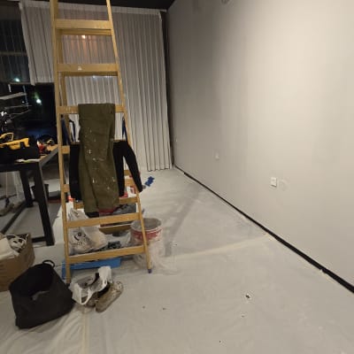 סולם עץ, דלי צבע, יריעות פלסטיק על הרצפה