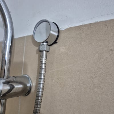 צינור מתכת מחובר לקיר עם מד לחץ