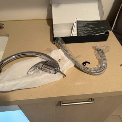 ברז וכבלים על משטח עבודה במטבח