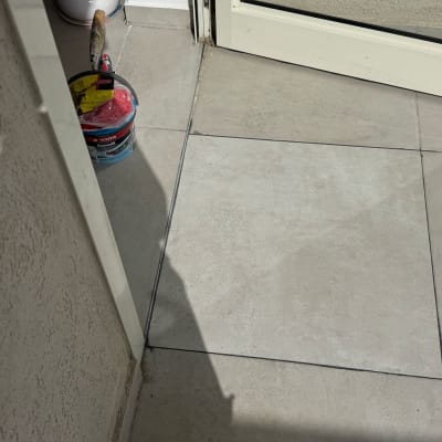 דלי צבע ומברשת על רצפת מרפסת