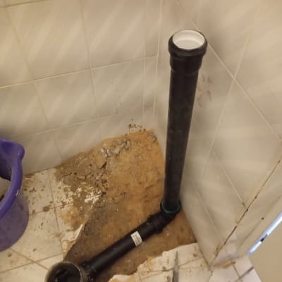 צינור ביוב שחור מותקן ברצפת חדר אמבטיה