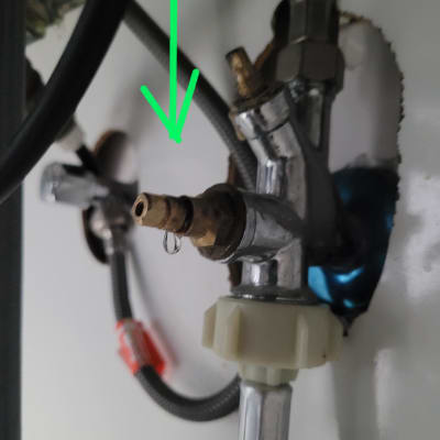 צנרת מתחת לכיור עם חיבורי מים ודליפה קטנה